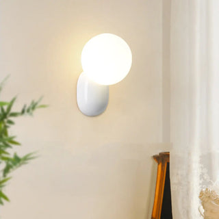 Modern Minimalist White Globe Resin LED Wall Light Zawala Image - 1